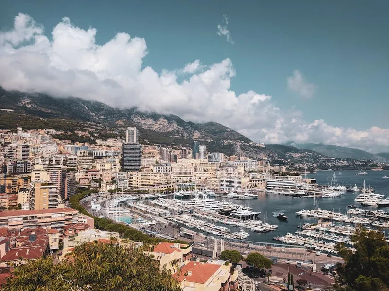 Edificios da cidade junto a agua sob ceu azul e nuvens brancas